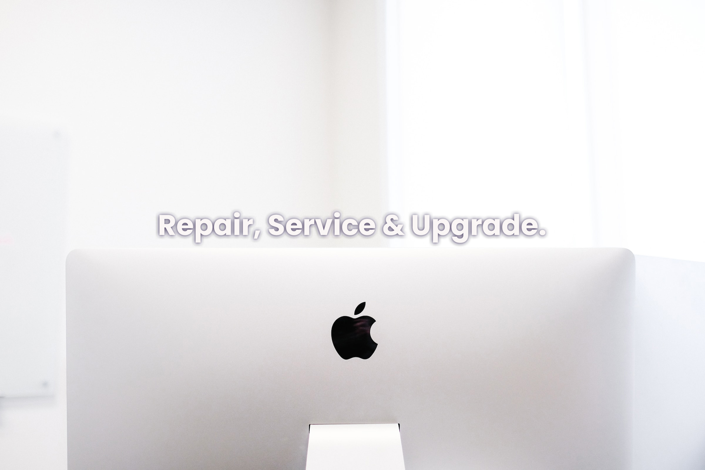 Back side of Apple iMac with 'Repair, Service & Upgrade' text